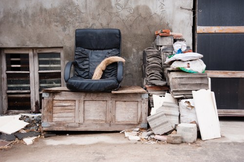Workers loading waste into a van at a shop refurbishment